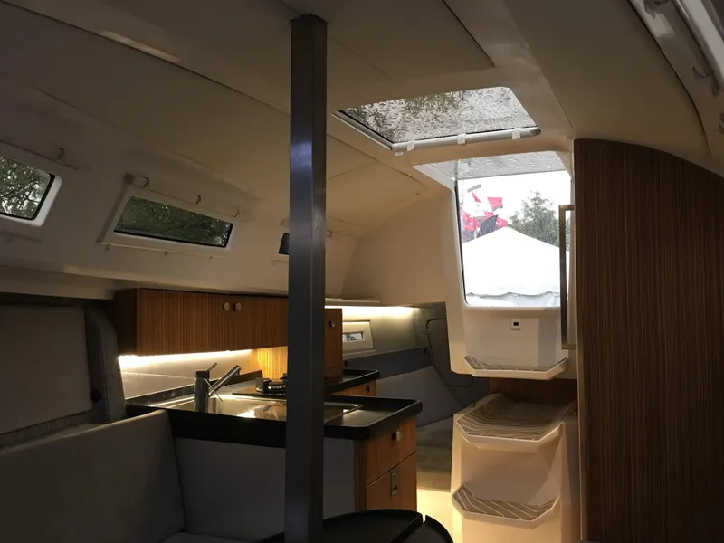 Slide: The Image of Interior of 2025 Faro Yachts 29, featuring modern kitchen and seating area. - 17