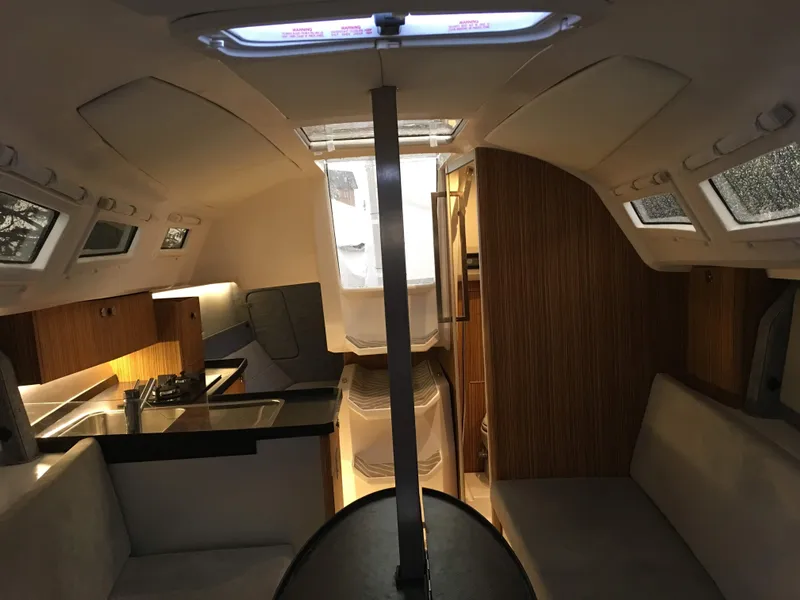 Slide: The Image of 2025 Faro Yachts 29 interior with modern kitchen and seating area. - 18