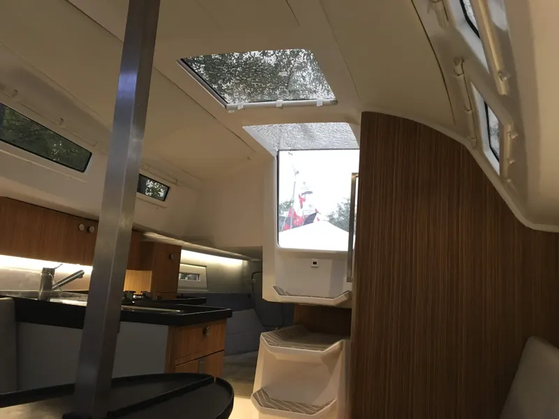 Slide: The Image of Interior of 2025 Faro Yachts 29, featuring modern design and wood accents. - 19