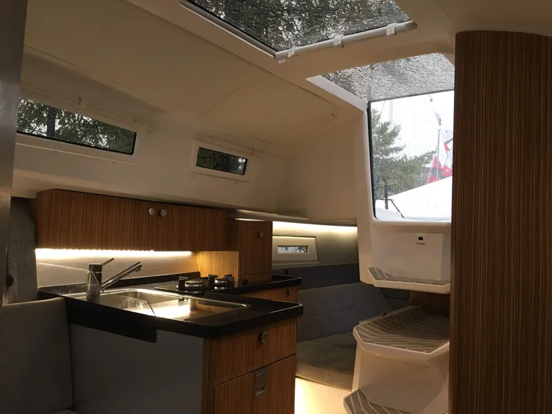 Slide: The Image of Modern interior of 2025 Faro Yachts 29, featuring sleek kitchen and seating area. - 20