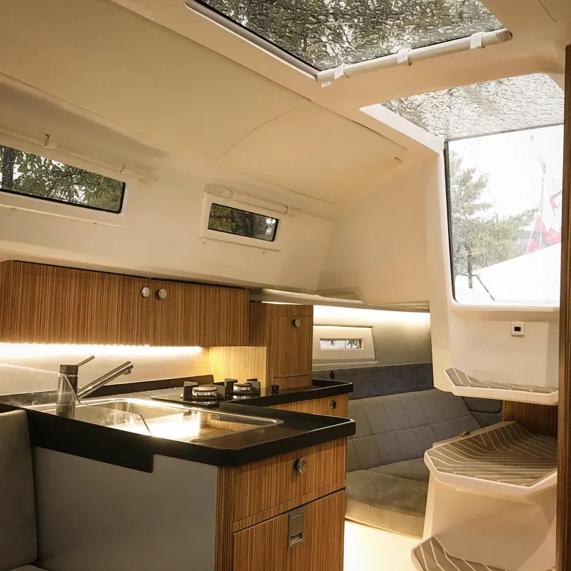 Slide: The Image of Luxurious interior of 2025 Faro Yachts 29, featuring modern kitchen and seating area. - 21