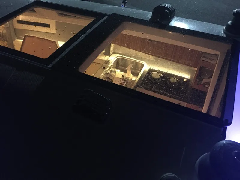 Slide: The Image of Interior view of 2025 Faro Yachts 29 through skylight, showcasing kitchen area. - 24