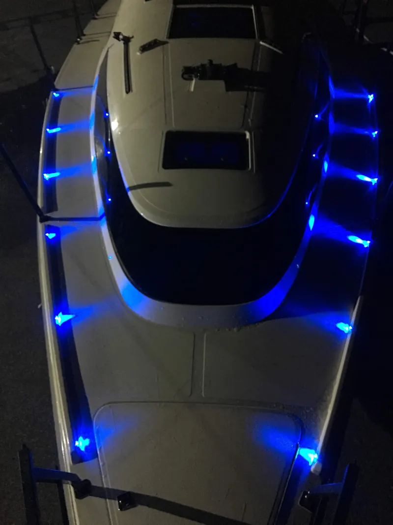 Slide: The Image of Faro Yachts 29, 2025 model, illuminated with blue LED lights at night. - 28