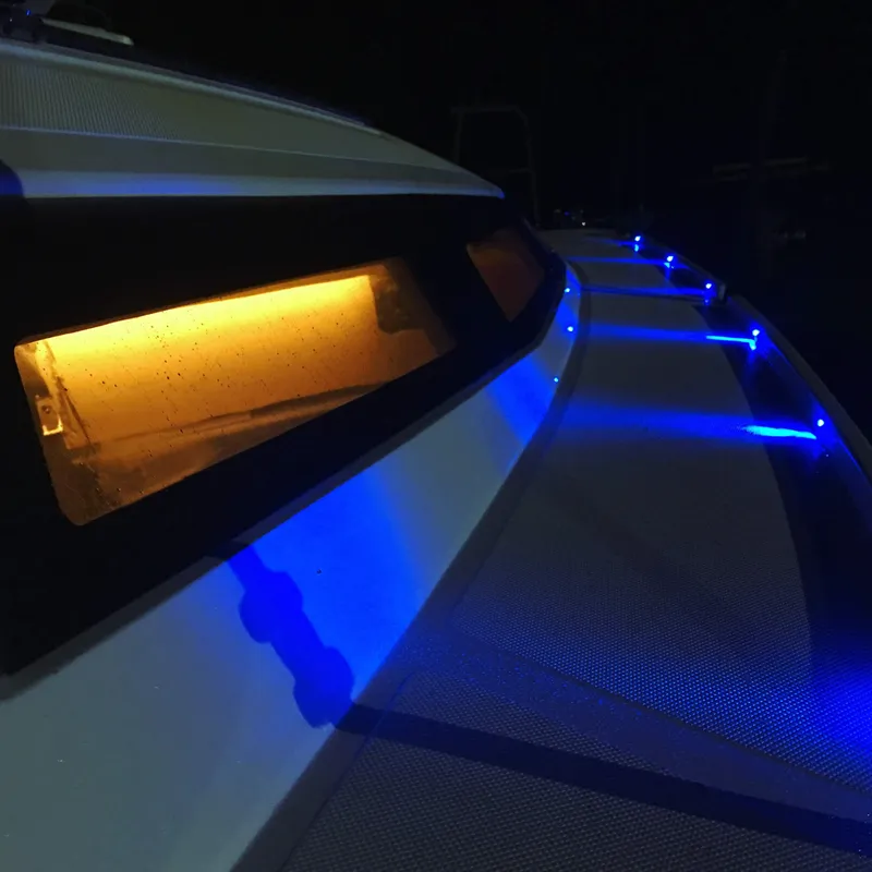 Slide: The Image of 2025 Faro Yachts 29 with illuminated blue and amber lights at night. - 29