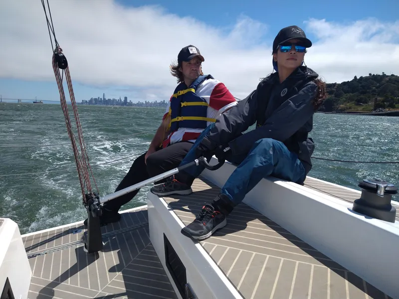 Slide: The Image of Two people sailing on a 2025 Faro Yachts 29 with city skyline in background. - 36