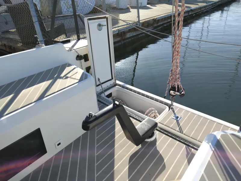 Slide: The Image of 2025 Faro Yachts 29 deck with open hatch and mooring ropes. - 6