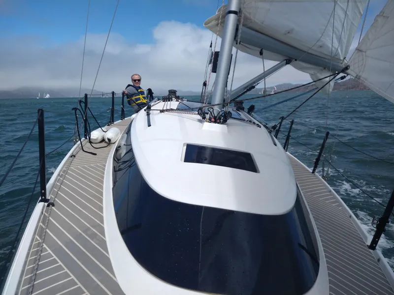 Slide: The Image of Sailing on a 2025 Faro Yachts 29 in open waters, clear skies above. - 7