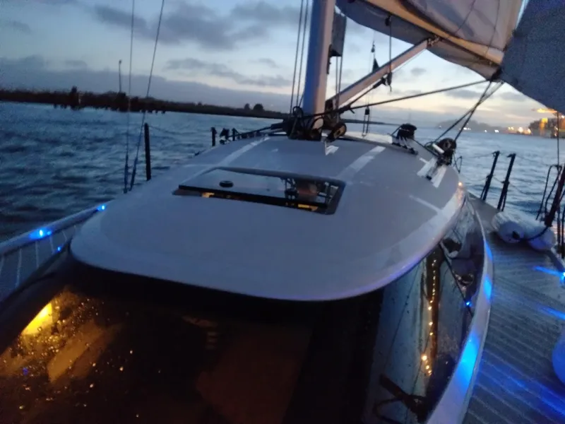 Slide: The Image of Sailing on a 2025 Faro Yachts 29 at dusk, illuminated by blue deck lights. - 8