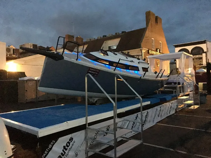 Slide: The Image of 2025 Faro Yachts 29 displayed on a platform at dusk, with blue accent lighting. - 9