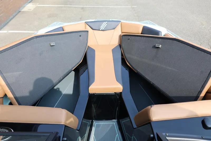 Slide: The Image of 2026 ATX Surf Boats 22 Type-S interior with tan seating and open storage compartments. - 34