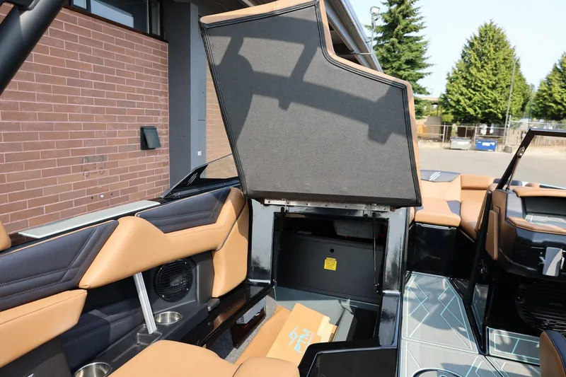 Slide: The Image of 2026 ATX Surf Boats 22 Type-S interior with open storage compartment and tan seating. - 35