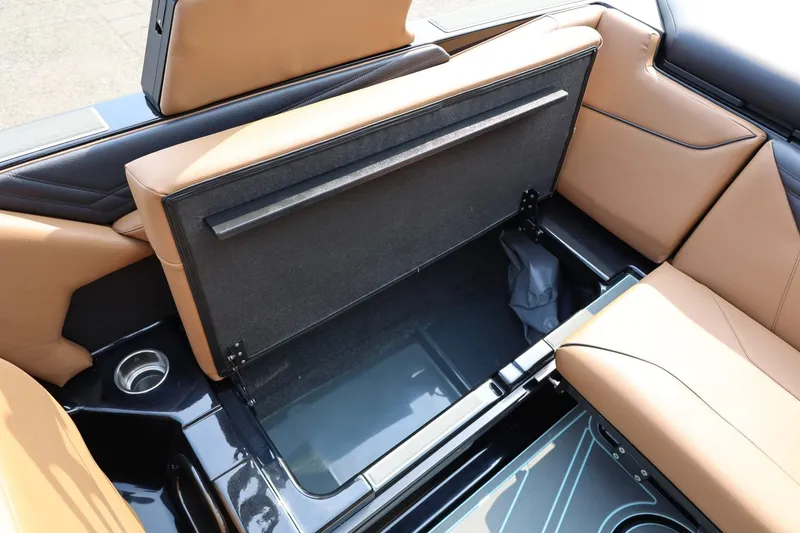 Slide: The Image of 2026 ATX Surf Boats 22 Type-S interior storage compartment with tan leather seating. - 36
