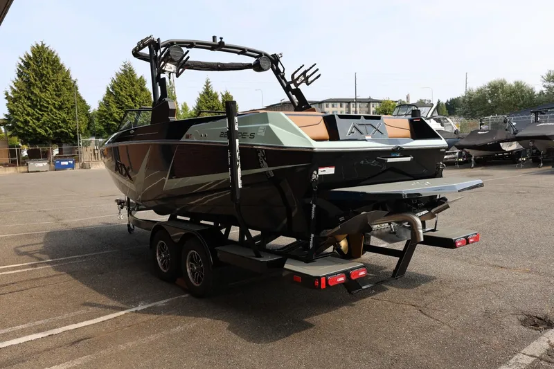 Slide: The Image of 2026 ATX Surf Boats 22 Type-S on trailer in parking lot, rear view. - 7