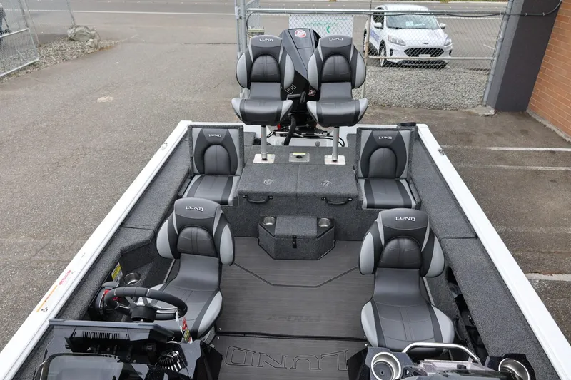 Slide: The Image of 2026 Lund 2075 Pro-V Bass XS boat interior with multiple gray seats and steering console. - 15