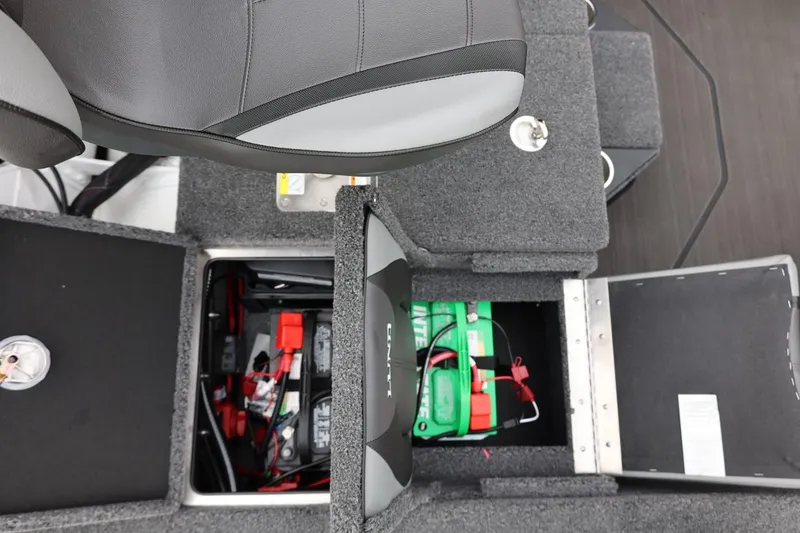 Slide: The Image of 2026 Lund 2075 Pro-V Bass XS boat interior with battery compartment open. - 18