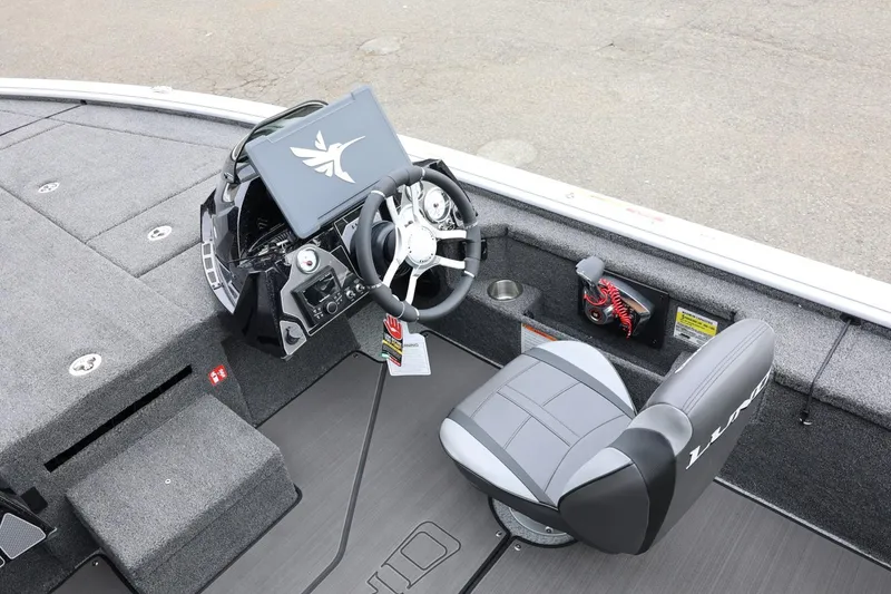 Slide: The Image of 2026 Lund 2075 Pro-V Bass XS boat interior with steering wheel and seat. - 20