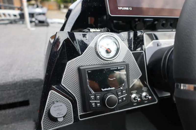 Slide: The Image of Dashboard of 2026 Lund 2075 Pro-V Bass XS with fuel gauge and audio controls. - 25