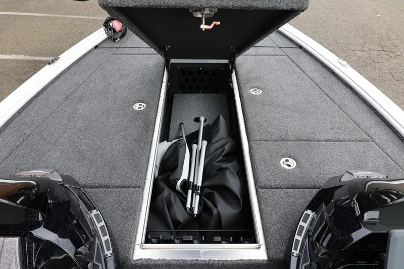 Slide: The Image of 2026 Lund 2075 Pro-V Bass XS boat storage compartment with equipment inside. - 35