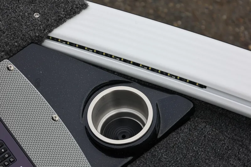 Slide: The Image of 2026 Lund 2075 Pro-V Bass XS boat interior with cup holder and LED strip lighting. - 41