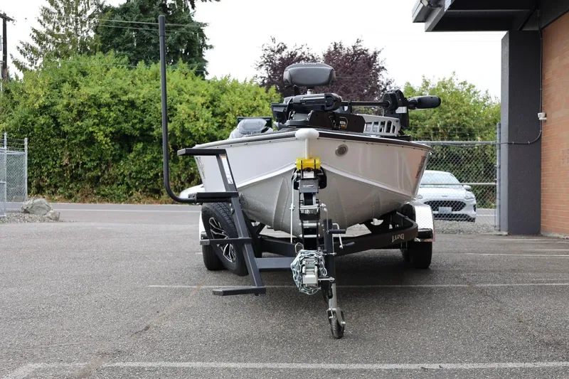 Slide: The Image of 2026 Lund 2075 Pro-V Bass XS boat on trailer in parking lot. - 6