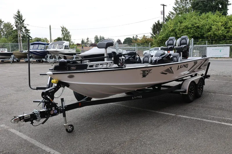 Slide: The Image of 2026 Lund 2075 Pro-V Bass XS boat on trailer in parking lot. - 7