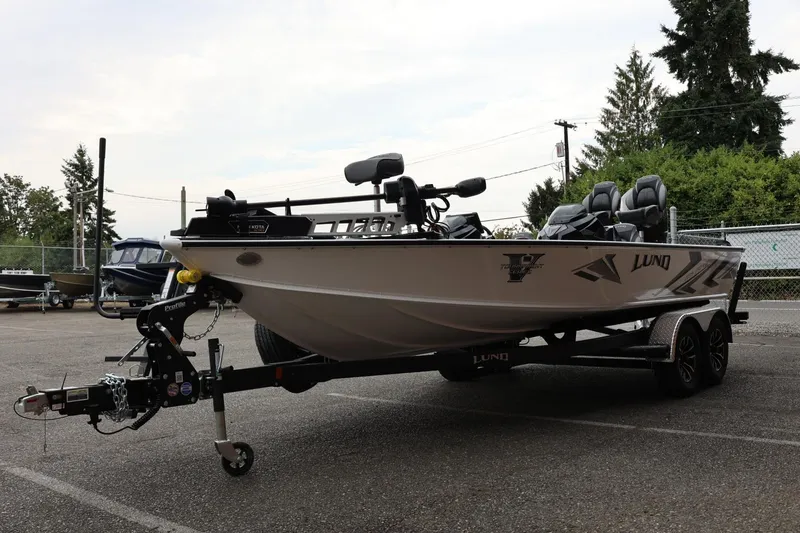 Slide: The Image of 2026 Lund 2075 Pro-V Bass XS boat on trailer in outdoor setting. - 8