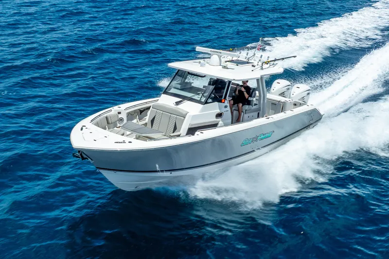 Slide: The Image of 2024 Pursuit S 358 Sport boat cruising on open blue water. - 1