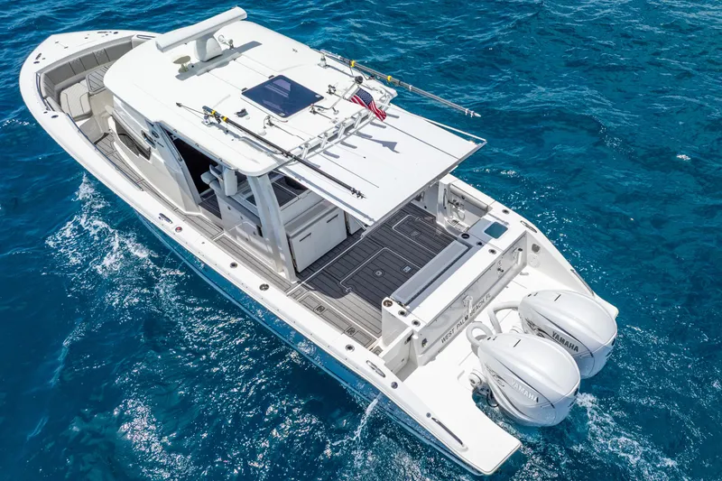 Slide: The Image of 2024 Pursuit S 358 Sport boat cruising on clear blue ocean waters. - 11