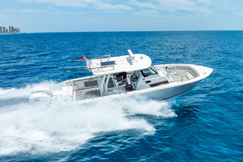 Slide: The Image of 2024 Pursuit S 358 Sport boat cruising on open blue ocean. - 12