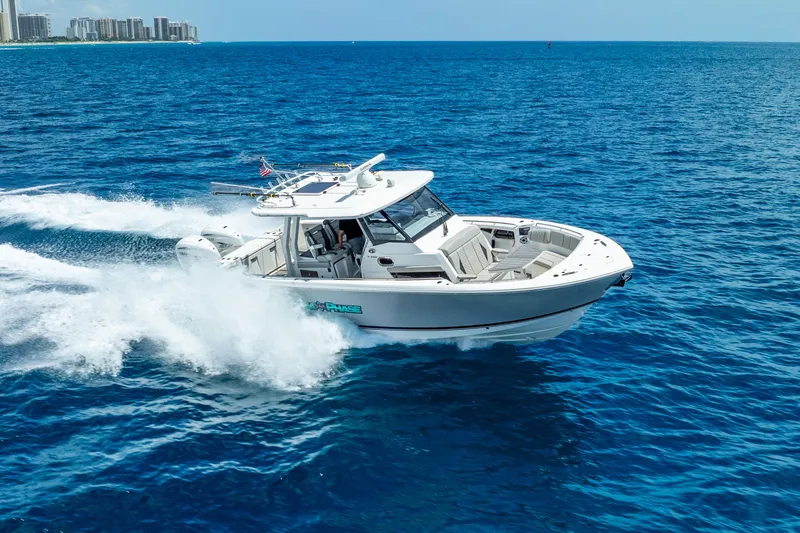 Slide: The Image of 2024 Pursuit S 358 Sport boat cruising on open blue ocean waters. - 13