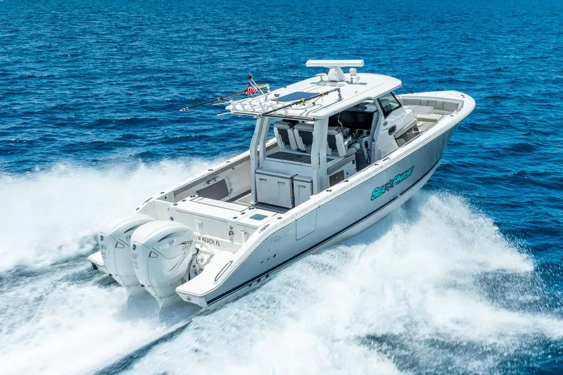 Slide: The Image of 2024 Pursuit S 358 Sport boat cruising on open blue water. - 15