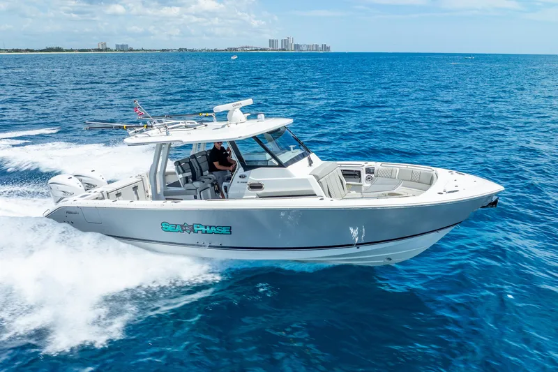 Slide: The Image of 2024 Pursuit S 358 Sport boat cruising on open blue ocean. - 17