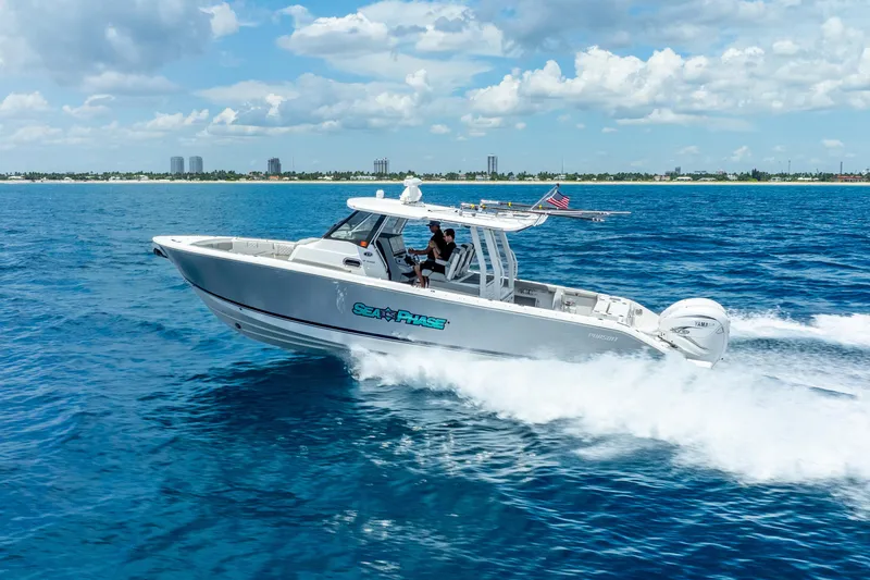 Slide: The Image of 2024 Pursuit S 358 Sport boat cruising on open blue water. - 2