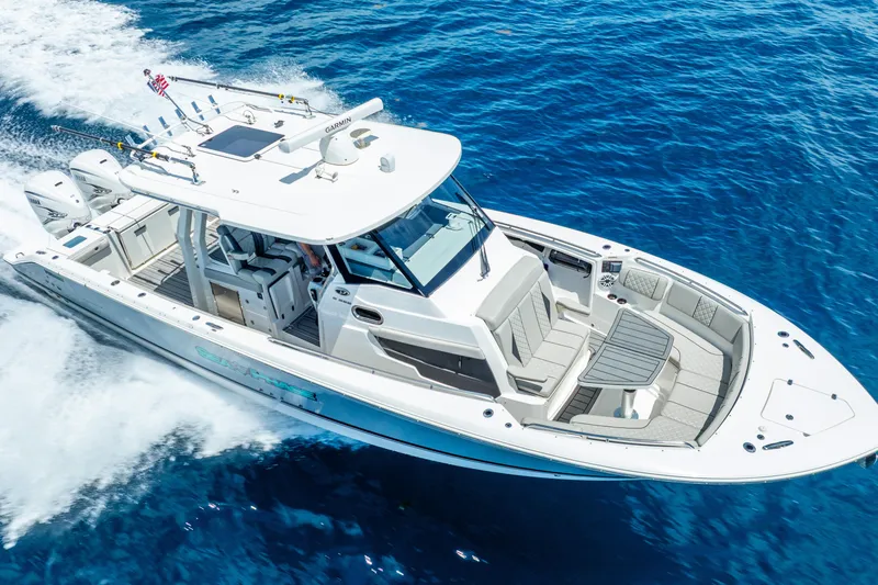 Slide: The Image of 2024 Pursuit S 358 Sport boat cruising on clear blue ocean waters. - 20