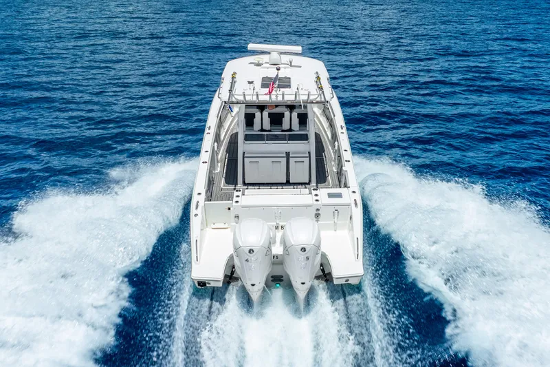 Slide: The Image of 2024 Pursuit S 358 Sport boat cruising on open blue water. - 21