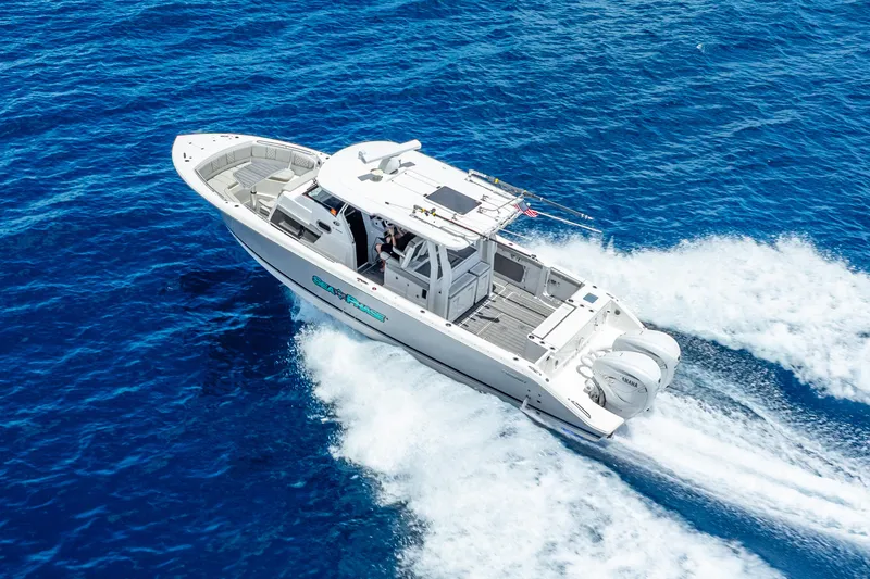 Slide: The Image of 2024 Pursuit S 358 Sport boat cruising on open blue ocean waters. - 22