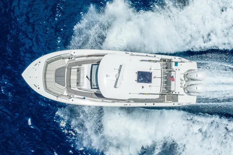 Slide: The Image of 2024 Pursuit S 358 Sport boat cruising on blue ocean waters, aerial view. - 23