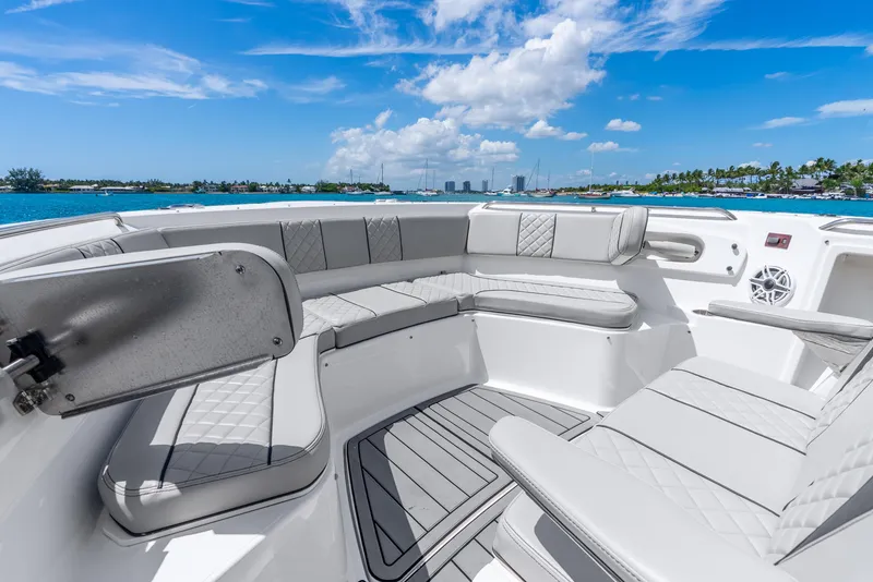 Slide: The Image of Luxurious seating on 2024 Pursuit S 358 Sport boat, with ocean view and blue sky. - 29