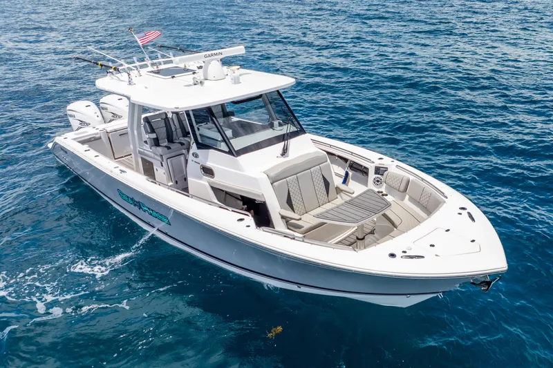 Slide: The Image of 2024 Pursuit S 358 Sport boat cruising on clear blue ocean waters. - 3