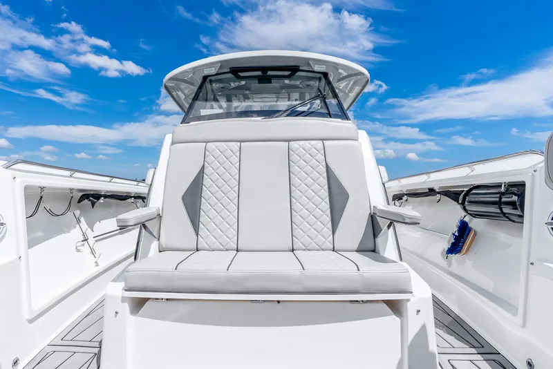 Slide: The Image of 2024 Pursuit S 358 Sport boat interior with luxurious seating under a clear blue sky. - 31