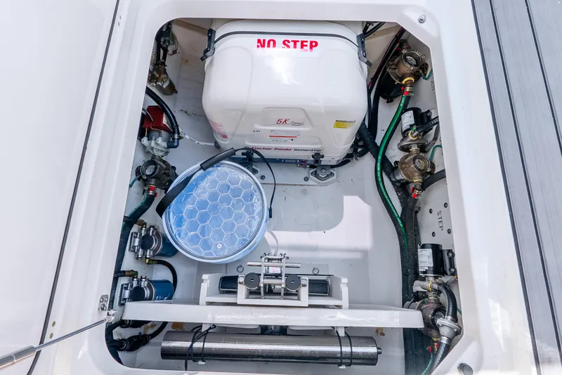Slide: The Image of 2024 Pursuit S 358 Sport boat engine compartment with generator and mechanical components. - 33