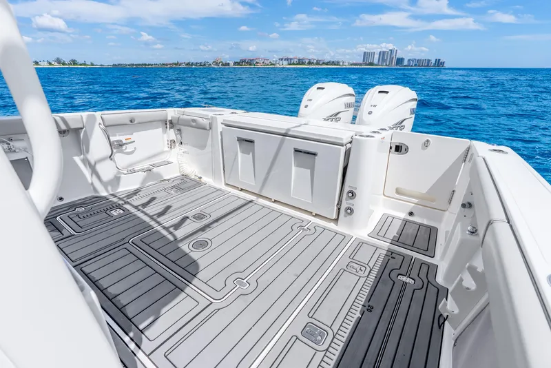 Slide: The Image of 2024 Pursuit S 358 Sport boat deck with dual engines, on a sunny day at sea. - 34