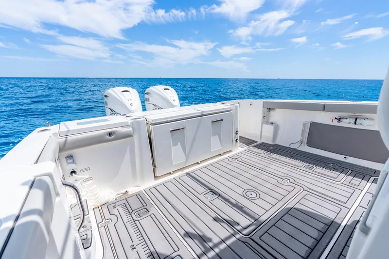 Slide: The Image of 2024 Pursuit S 358 Sport boat deck with ocean view and clear blue sky. - 36