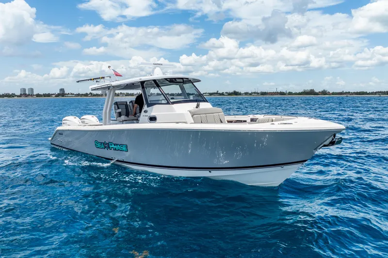 Slide: The Image of 2024 Pursuit S 358 Sport boat cruising on clear blue ocean waters. - 4