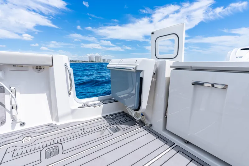 Slide: The Image of 2024 Pursuit S 358 Sport boat interior with ocean view, featuring sleek design and modern amenities. - 42