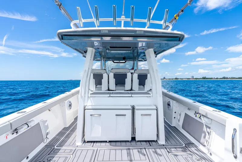 Slide: The Image of 2024 Pursuit S 358 Sport boat on open sea under clear blue sky. - 44