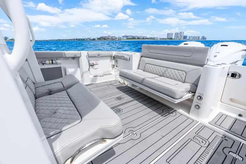 Slide: The Image of 2024 Pursuit S 358 Sport boat interior with luxurious seating and ocean view. - 46
