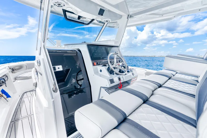 Slide: The Image of 2024 Pursuit S 358 Sport boat interior with sleek design and ocean view. - 49