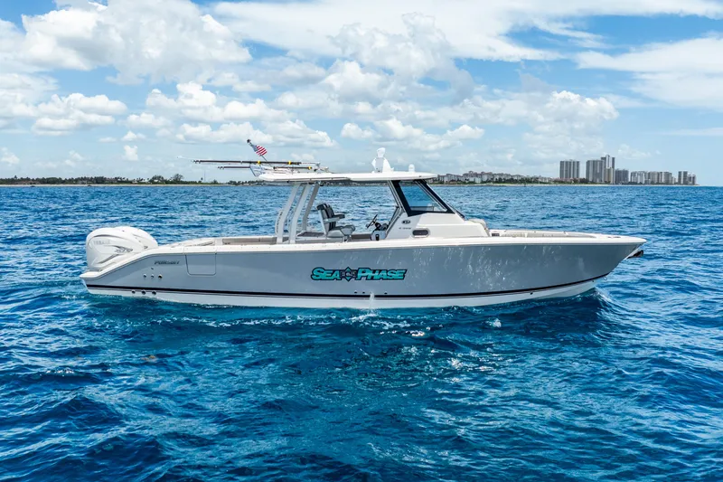 Slide: The Image of 2024 Pursuit S 358 Sport boat cruising on blue ocean under clear sky. - 5