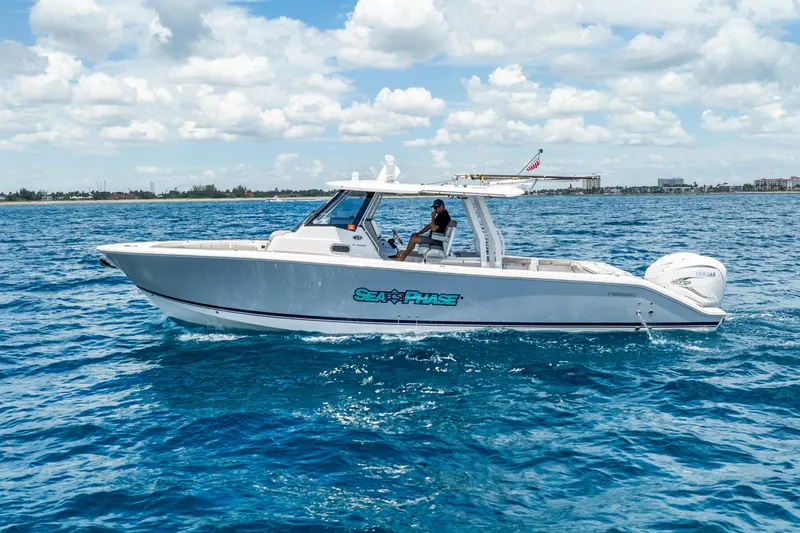 Slide: The Image of 2024 Pursuit S 358 Sport boat cruising on blue ocean under cloudy sky. - 9